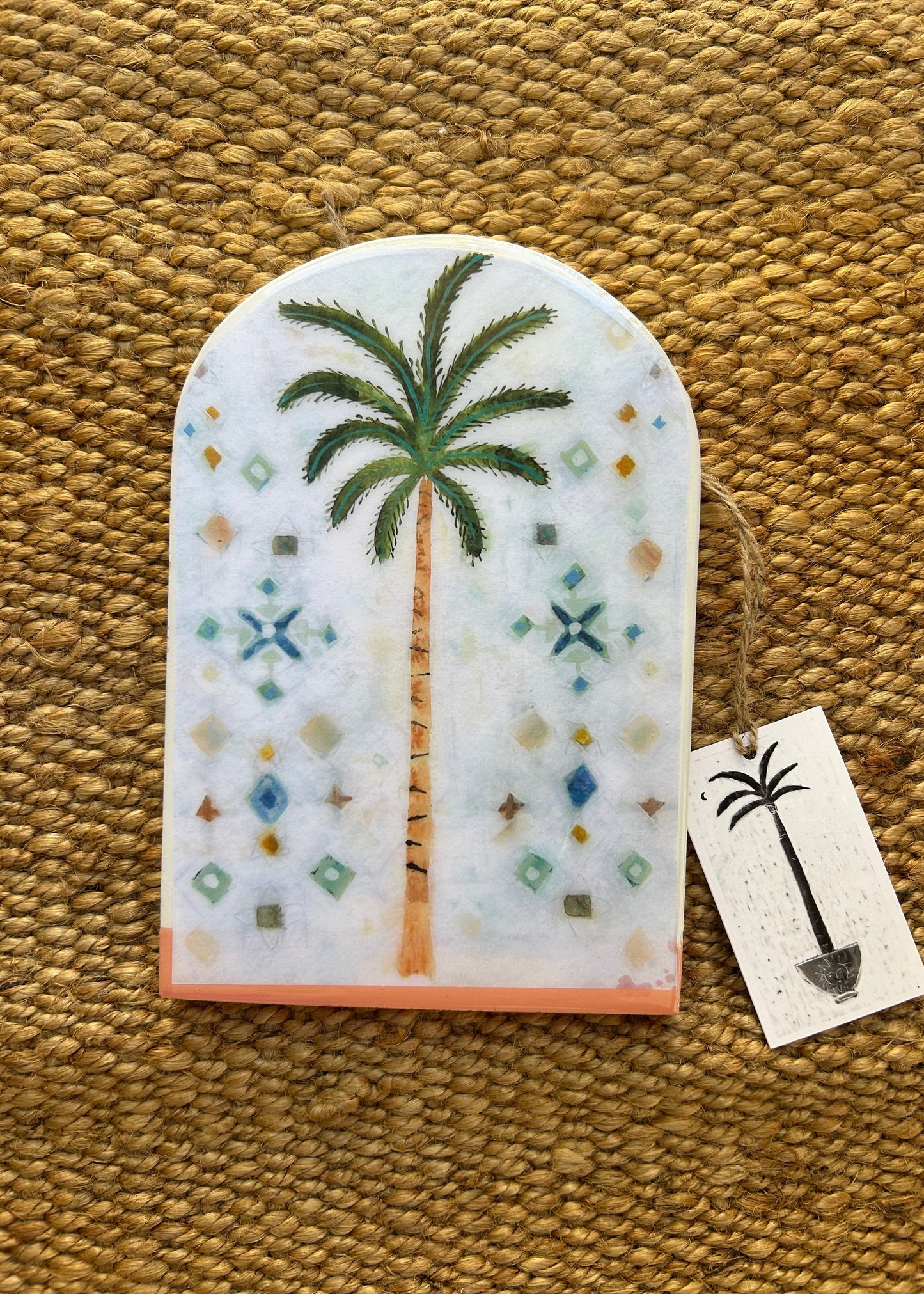 Decorative item with palm tree design on a textured surface