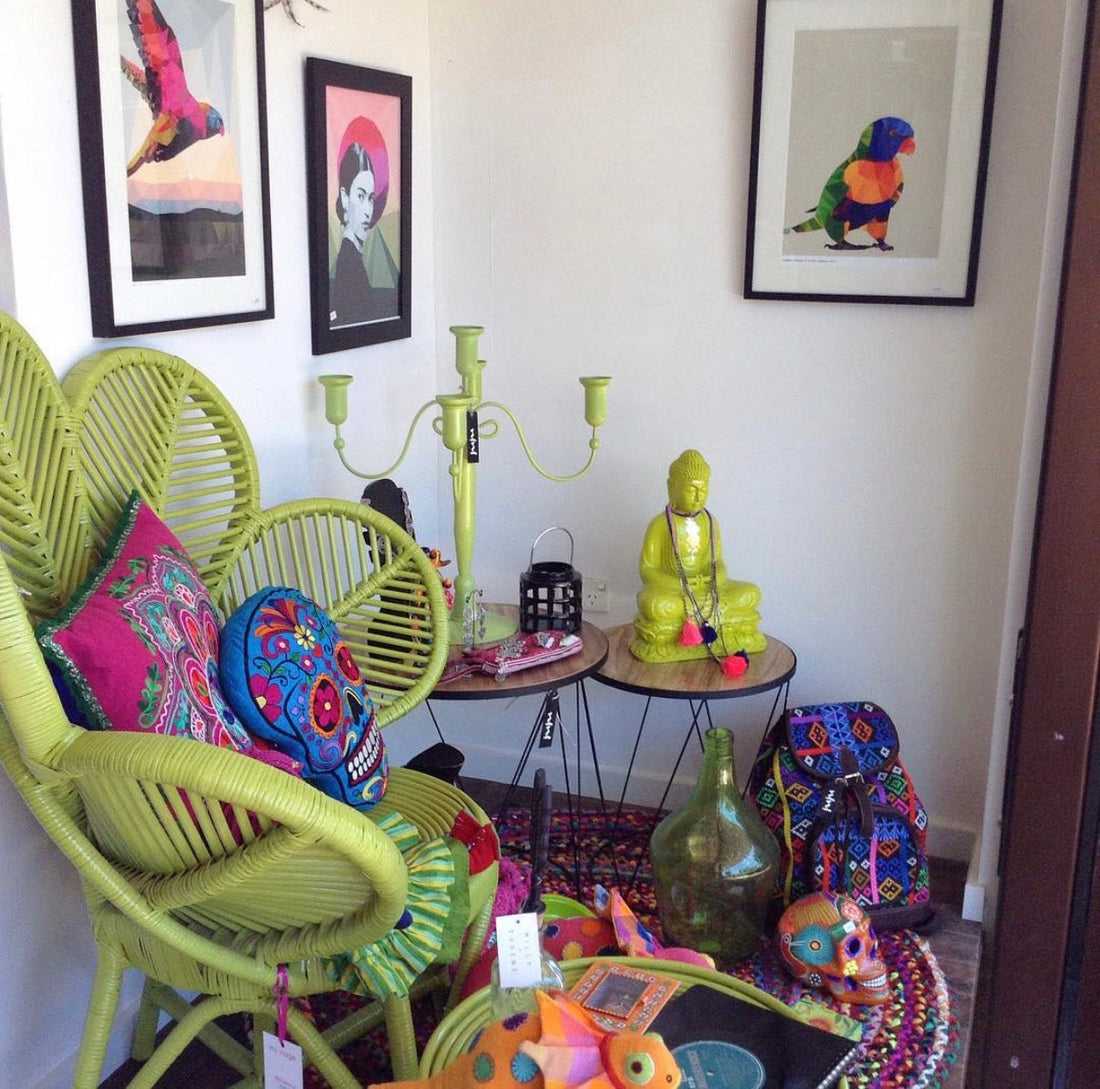 Colourful shop window display featuring handmade textiles, art and prints and decorator pieces