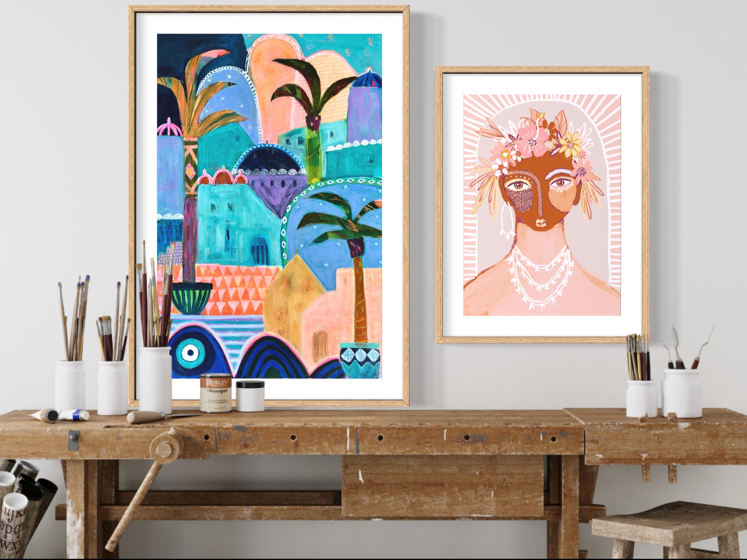 Artist studio wall with Moroccan style art work in multi colours and a framed fine art print of a warrior woman