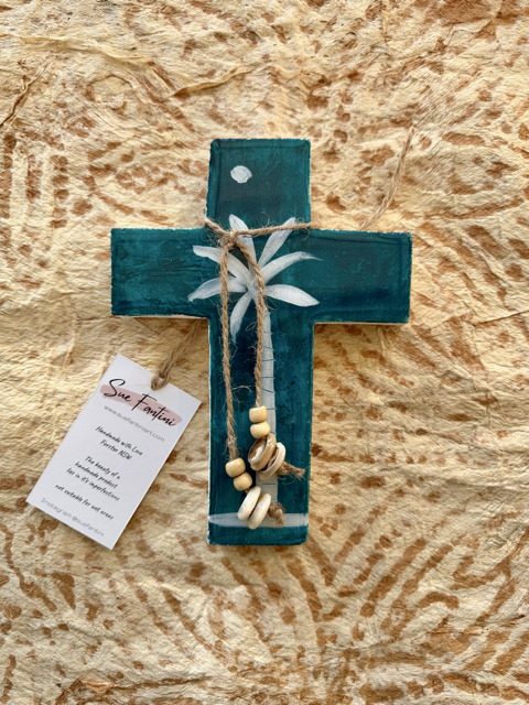 Teal plaster cross with palm tree and shell tassle
