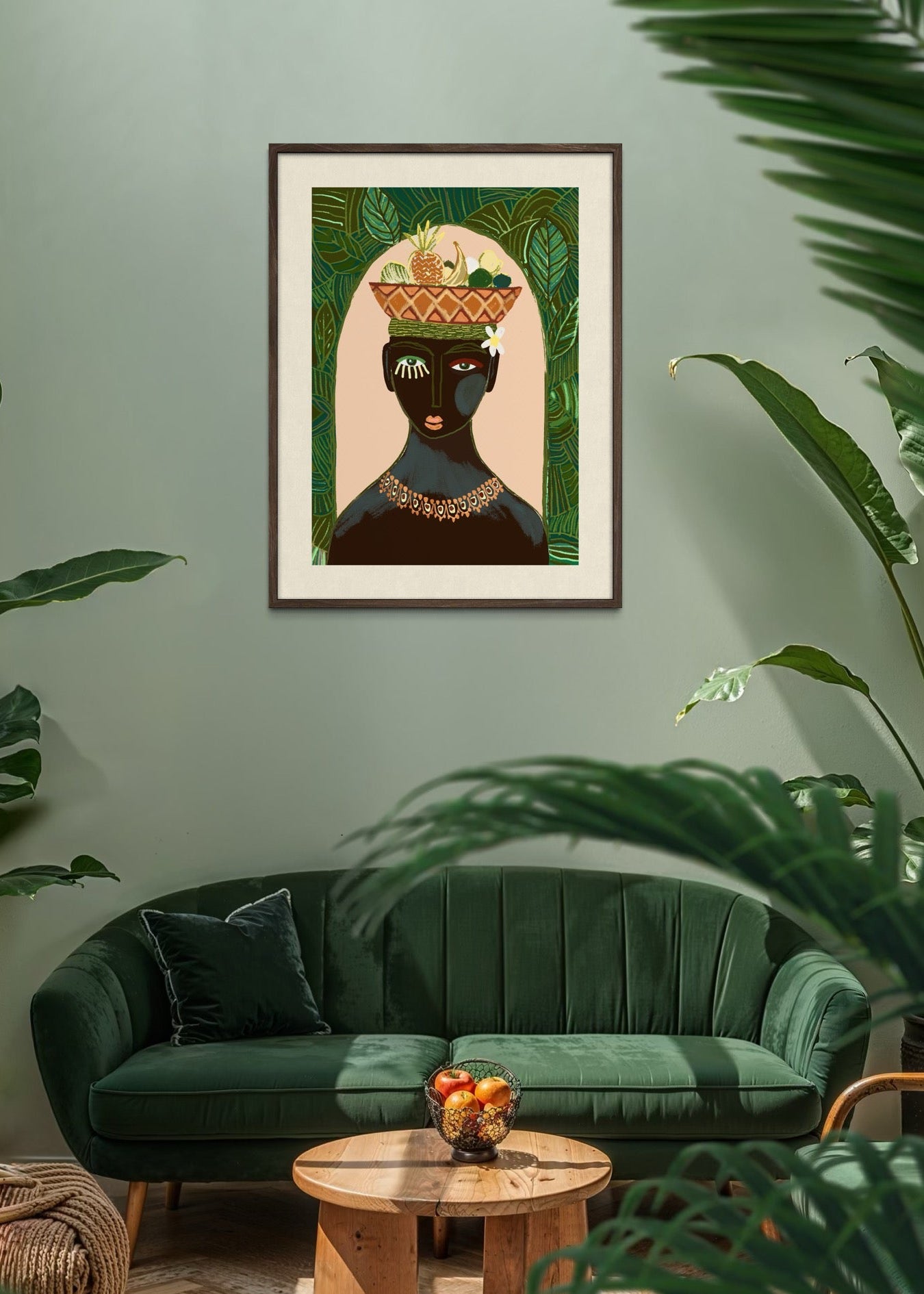 Framed artwork of a black woman with a fruit bowl on her head  in a living room with green sofa and plants.