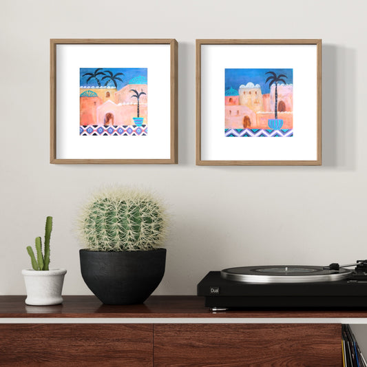 Set of Moroccan art prints in blue, pink and rusts framed in timber on wall with plants